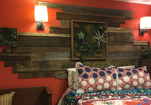 Vertical wall art by Urban Garden Studio | Faux succulent boxes and reclaimed wood give this room a splash of color Vertical wall garden, Living wall, reclaimed wood, moss, succulents, ferns, planters, custom logos, bedroom wall design, living garden wall art, indoor living wall art